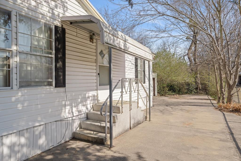 220 North Houston Street Edgewood, TX 75117 - Photo 3 of 30 a view of backyard with cabin