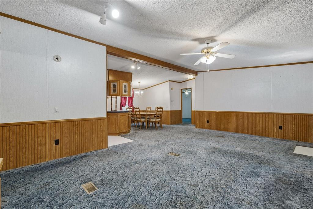 220 North Houston Street Edgewood, TX 75117 - Photo 6 of 30 an empty room with closet and chandelier fan