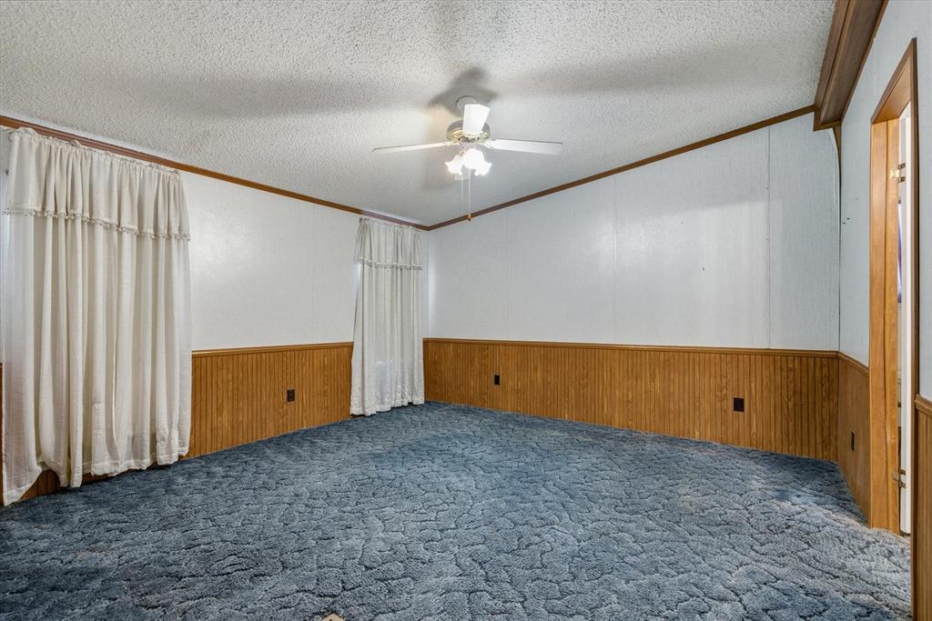 220 North Houston Street Edgewood, TX 75117 - Photo 8 of 30 an empty room with a ceiling fan and window