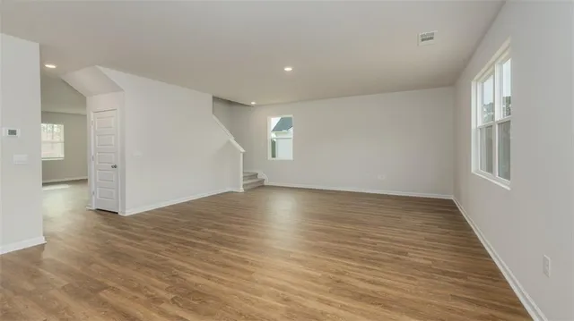 wooden floor in an empty room with a window