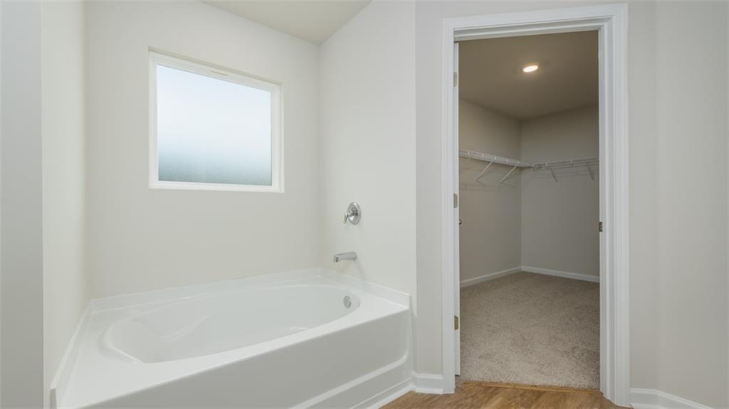 1949 Van Alen Court Dacula, GA 30019 - Photo 30 of 46 a en suite bathroom with a bathtub and window