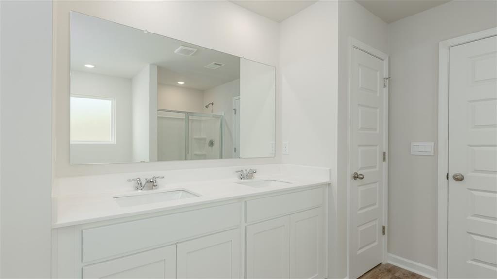 1949 Van Alen Court Dacula, GA 30019 - Photo 33 of 46 a bathroom with a sink and a mirror