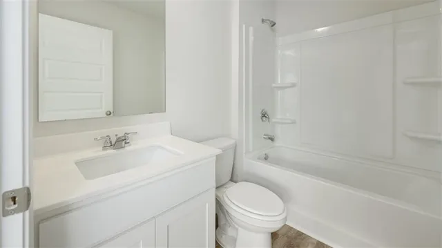 a bathroom with a toilet a sink and bathtub
