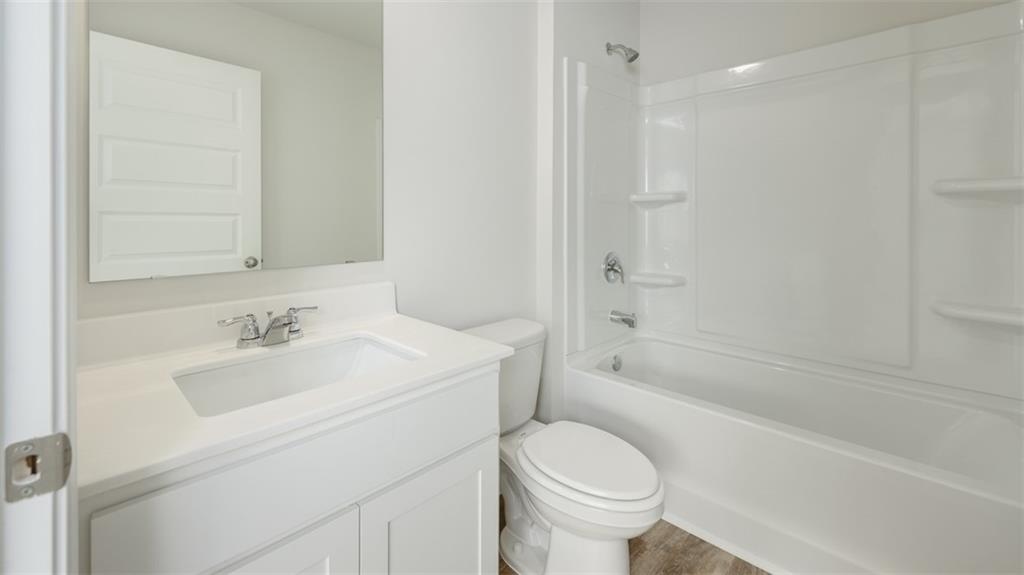1949 Van Alen Court Dacula, GA 30019 - Photo 39 of 46 a bathroom with a sink a toilet and a bathtub