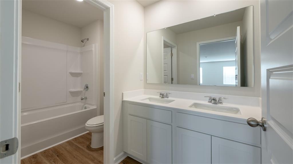 1949 Van Alen Court Dacula, GA 30019 - Photo 40 of 46 a bathroom with a toilet a sink and bathtub