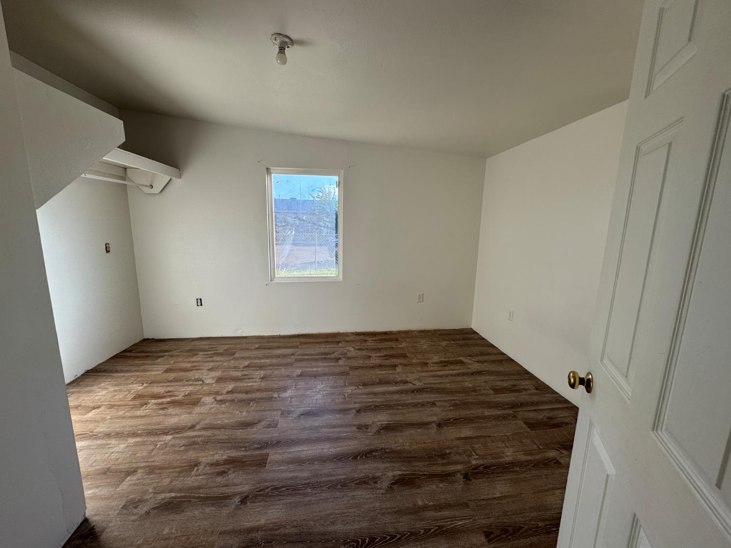 687 South 8th Street Kerman, CA 93630 - Photo 15 of 16 a view of empty room with wooden floor