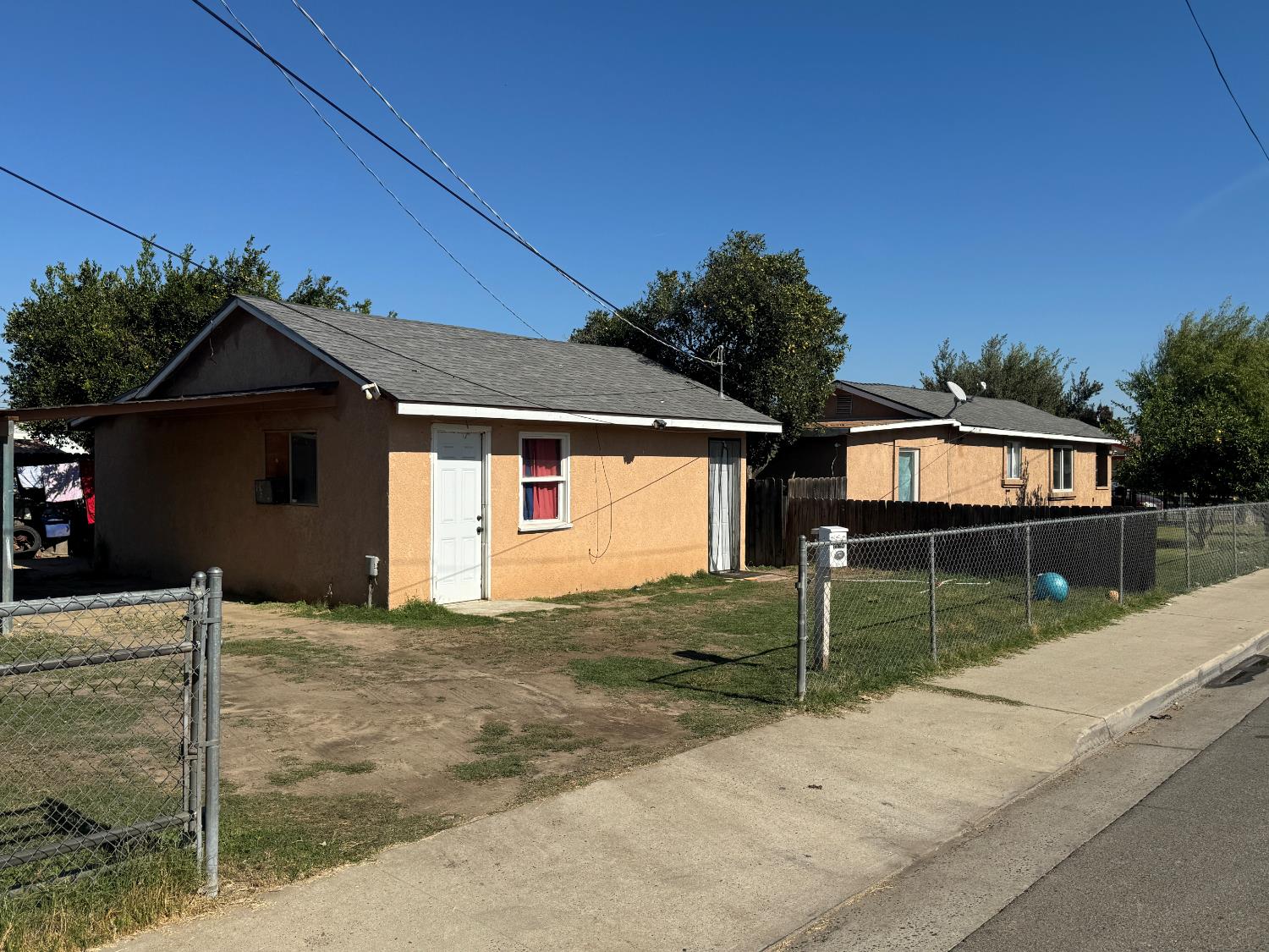 687 South 8th Street Kerman, CA 93630 - Photo 2 of 16 a front view of a house with a yard