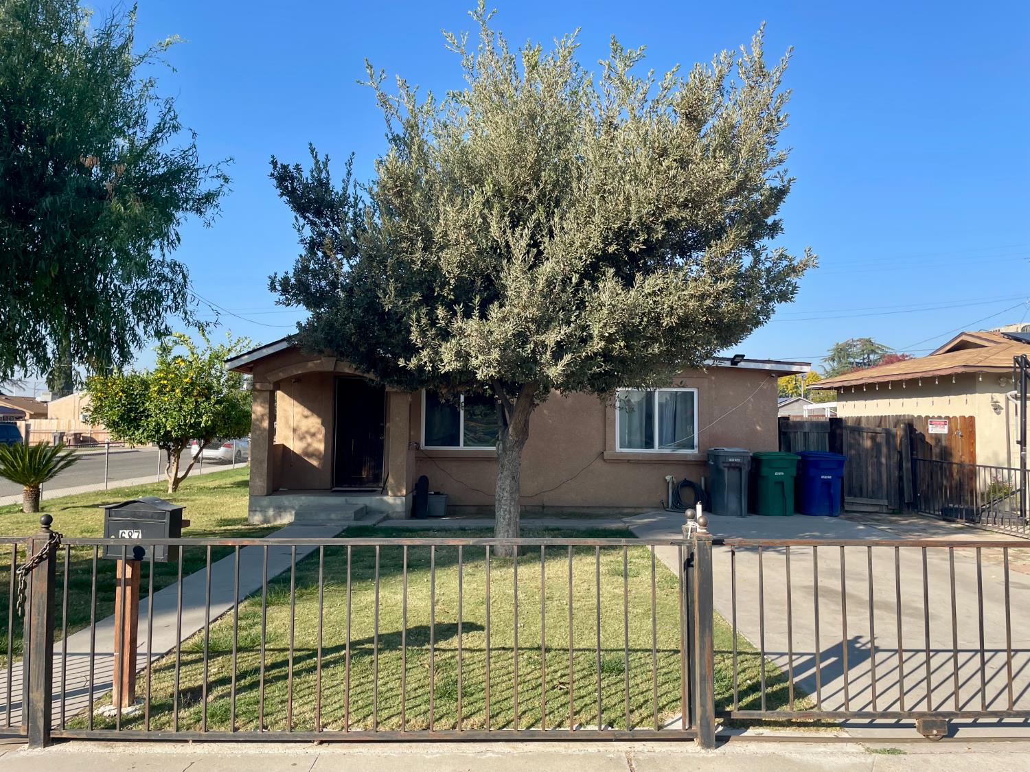 687 South 8th Street Kerman, CA 93630 - Photo 3 of 16 a view of house with swimming pool and a yard