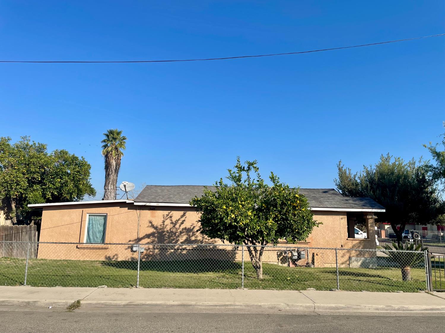 687 South 8th Street Kerman, CA 93630 - Photo 5 of 16 a front view of a house with garden
