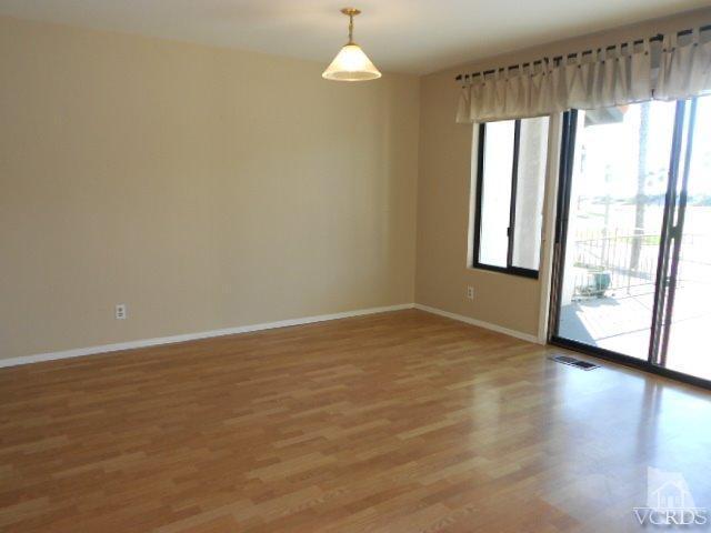 2201 Vina Del Mar Oxnard, CA 93035 - Photo 15 of 48 an empty room with wooden floor and windows