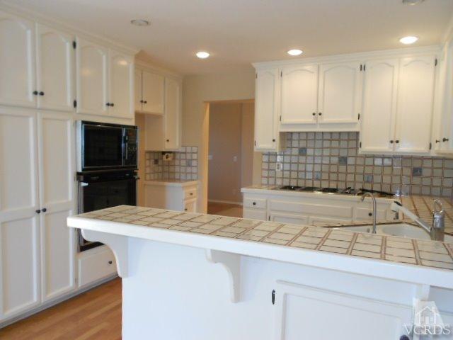 2201 Vina Del Mar Oxnard, CA 93035 - Photo 19 of 48 a kitchen with stainless steel appliances kitchen island granite countertop a sink and a refrigerator