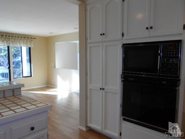 2201 Vina Del Mar Oxnard, CA 93035 - Photo 21 of 48 a view of kitchen with granite countertop cabinets and refrigerator