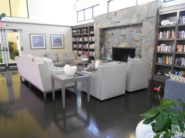 2201 Vina Del Mar Oxnard, CA 93035 - Photo 39 of 48 a living room with furniture a bookshelf and a fireplace