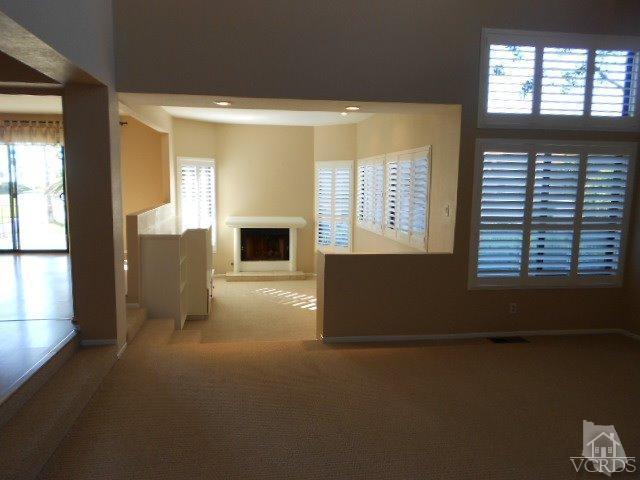 2201 Vina Del Mar Oxnard, CA 93035 - Photo 9 of 48 view of an empty room with a fireplace and a window