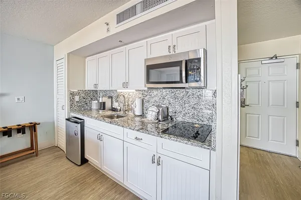 a view of a dining room with furniture and a chandelier