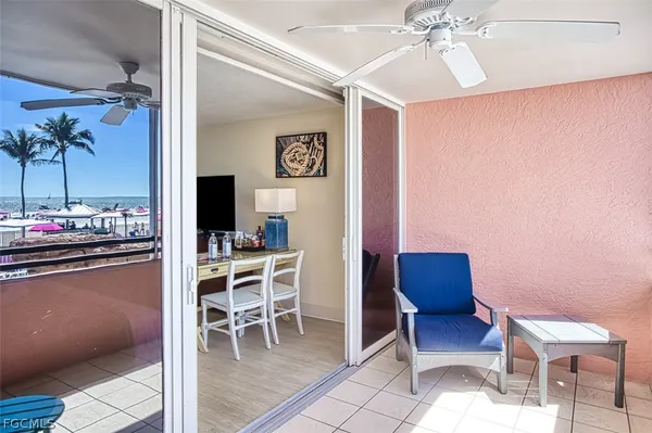 a bedroom with furniture and a chandelier fan