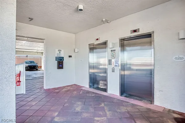 a spacious bedroom with a bed a table and large mirror