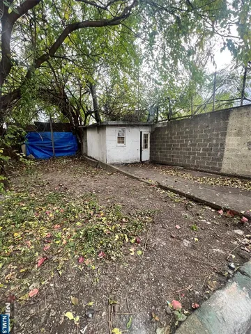 a view of a backyard with large trees