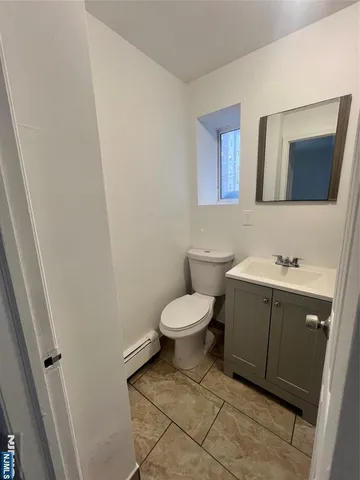 a kitchen with granite countertop a stove top oven and cabinets