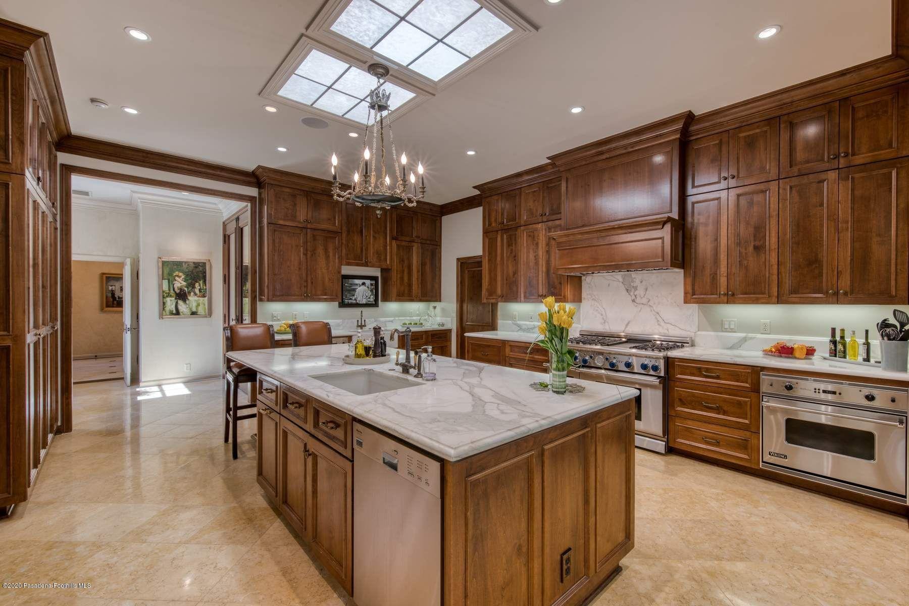 400 South San Rafael Avenue Pasadena, CA 91105 - Photo 11 of 49 a kitchen with a stove a sink a refrigerator and chairs