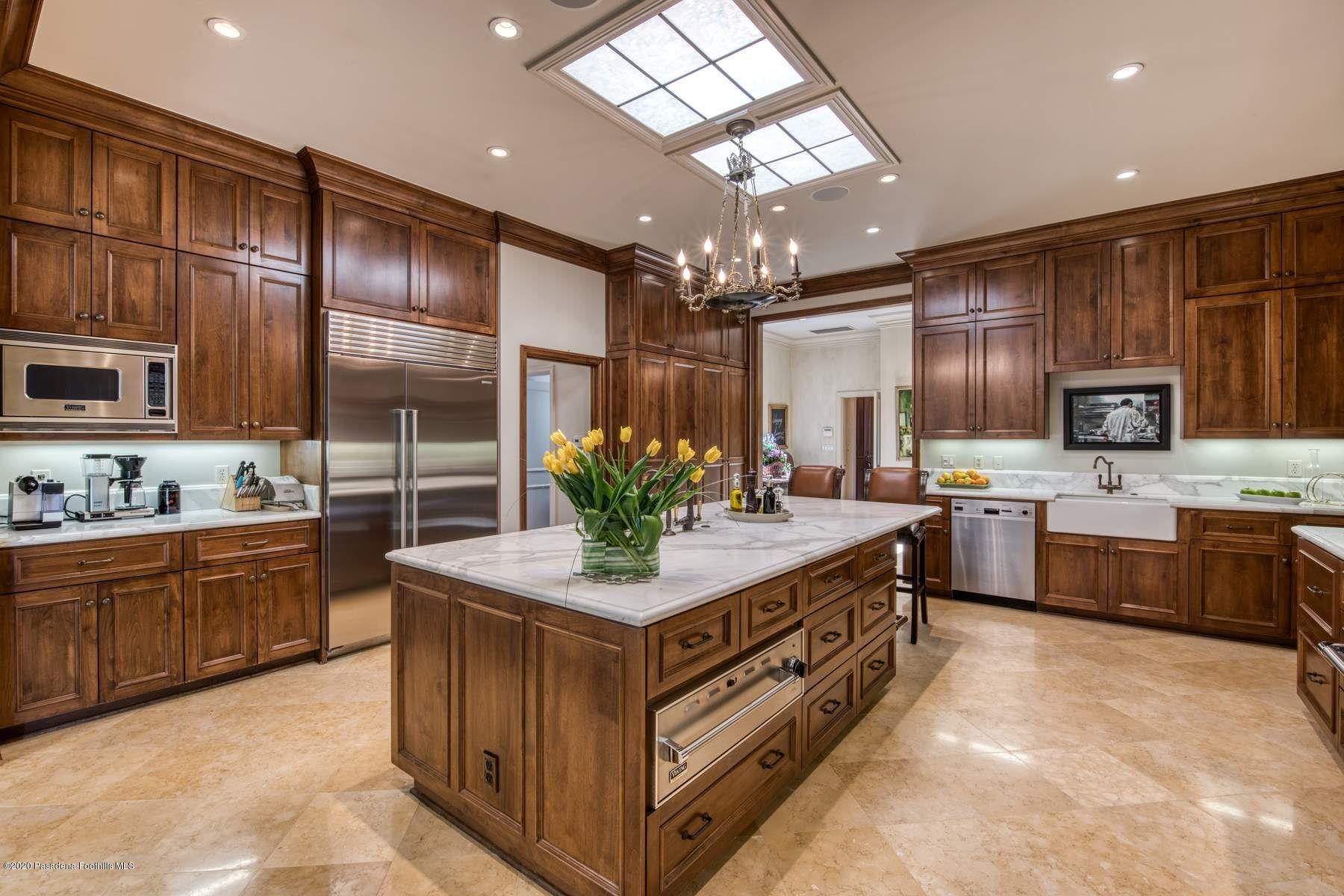 400 South San Rafael Avenue Pasadena, CA 91105 - Photo 12 of 49 a kitchen with stainless steel appliances kitchen island granite countertop a stove refrigerator and cabinets