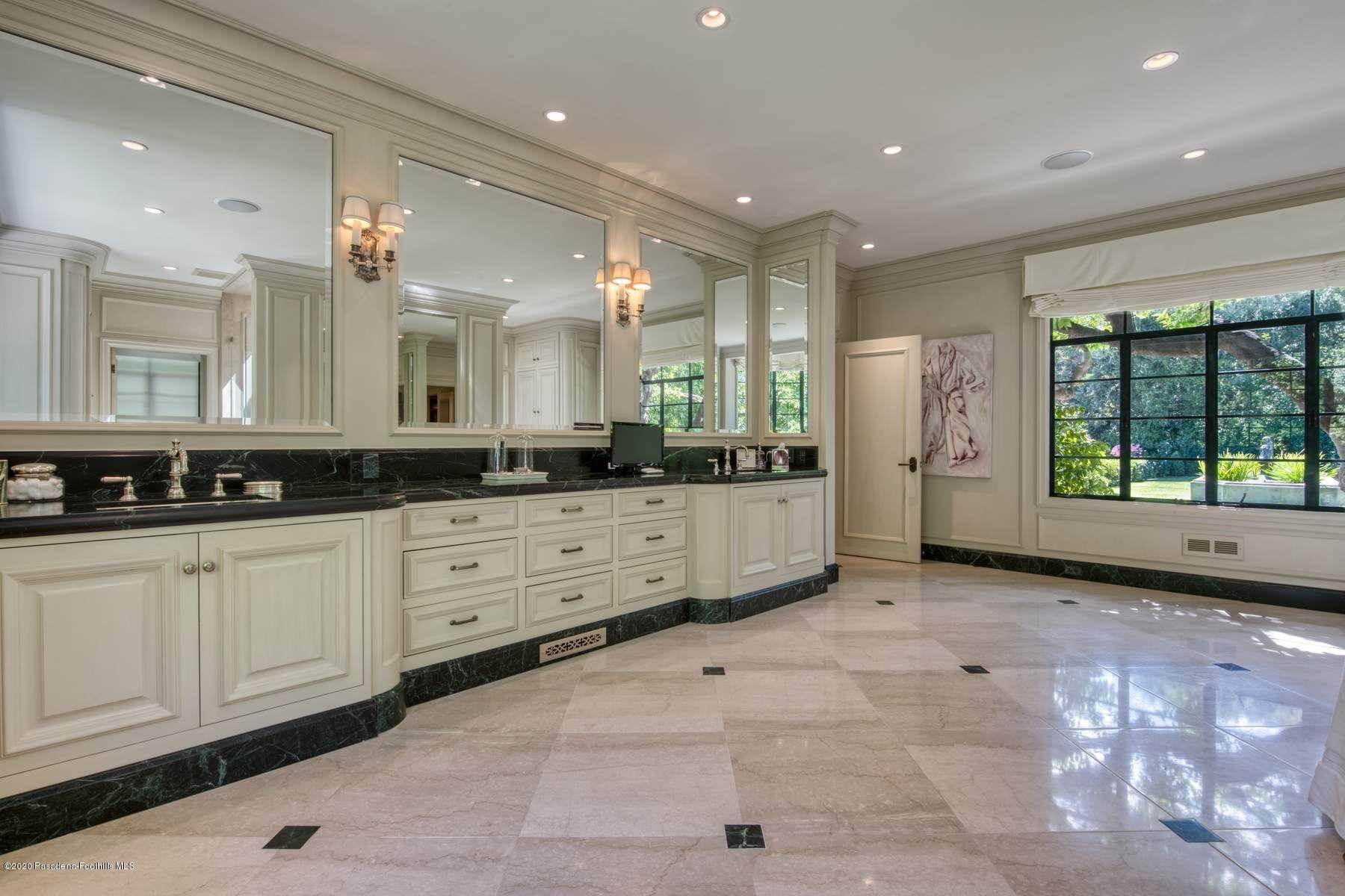 400 South San Rafael Avenue Pasadena, CA 91105 - Photo 23 of 49 a large bathroom with a large mirror vanity and shower