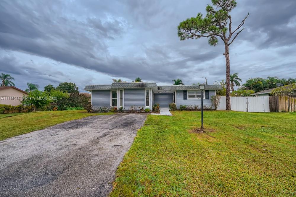 115 West Mango Road Lake Worth, FL 33467 - Photo 1 of 32 a view of a house with a yard