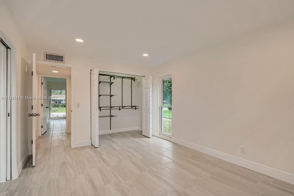 115 West Mango Road Lake Worth, FL 33467 - Photo 16 of 32 wooden floor in an empty room with a window