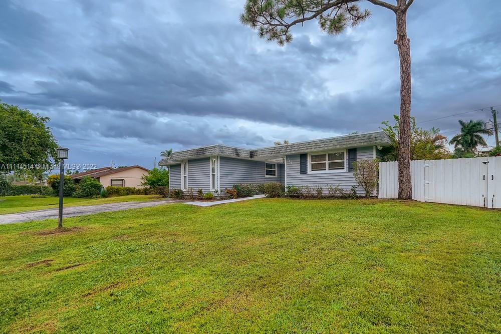 115 West Mango Road Lake Worth, FL 33467 - Photo 2 of 32 a view of a house with a yard