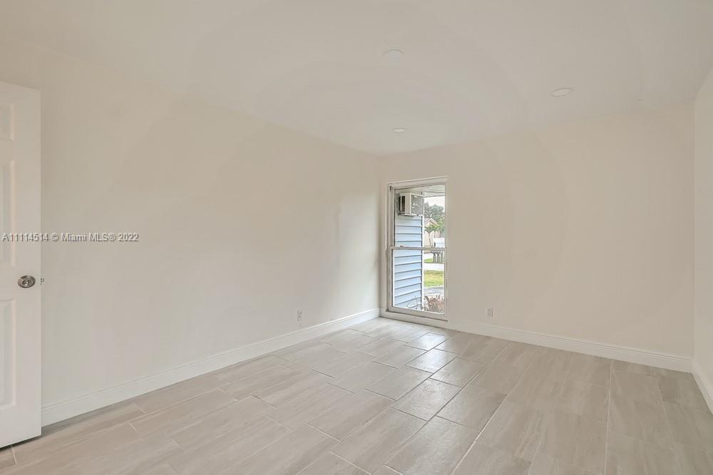 115 West Mango Road Lake Worth, FL 33467 - Photo 23 of 32 a view of an empty room with a window