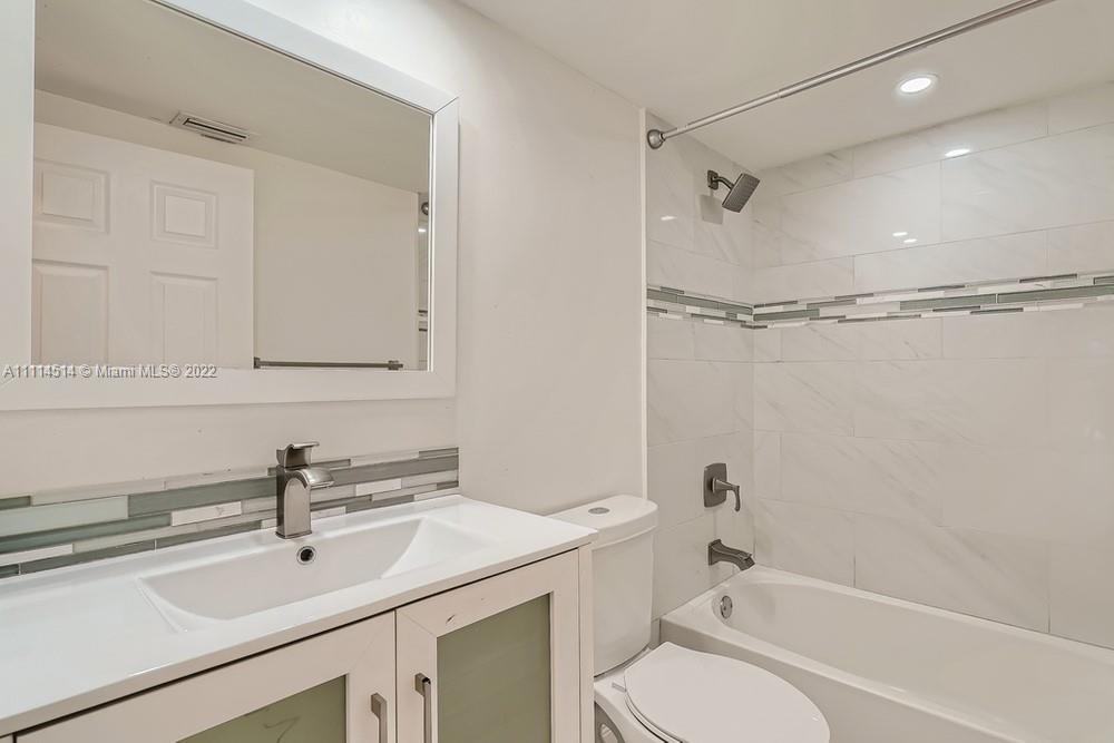 115 West Mango Road Lake Worth, FL 33467 - Photo 26 of 32 a bathroom with a sink toilet tub and shower