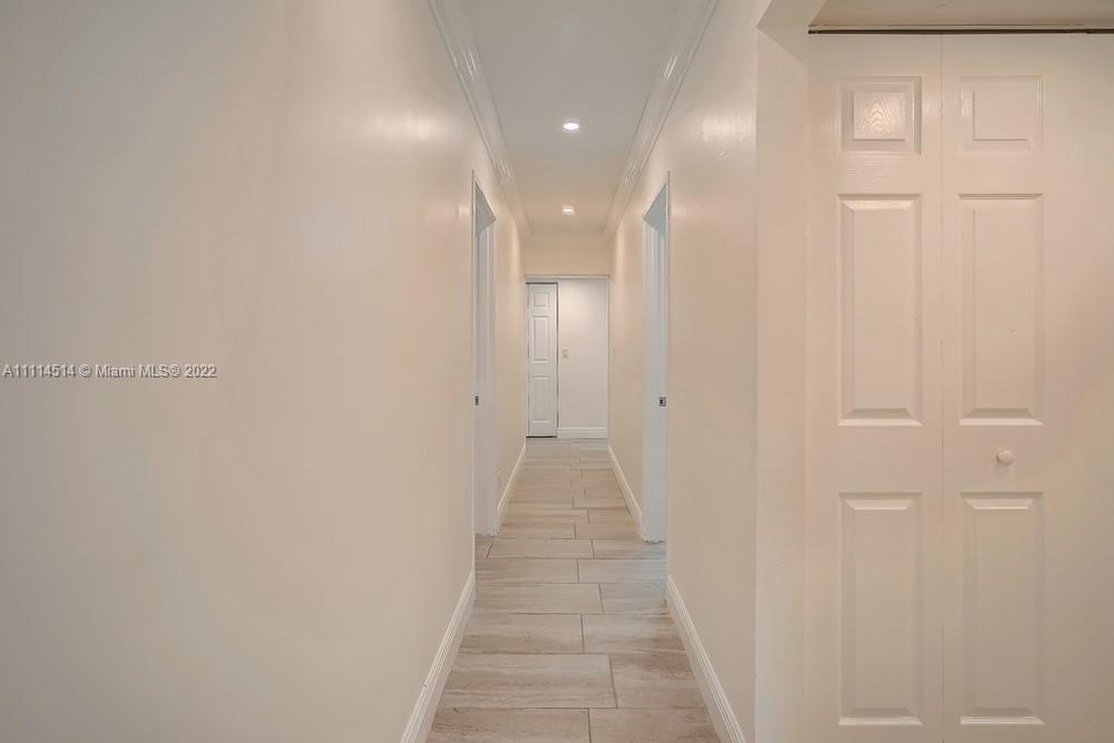 115 West Mango Road Lake Worth, FL 33467 - Photo 29 of 32 a view of a hallway with wooden floor