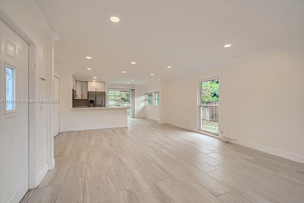 115 West Mango Road Lake Worth, FL 33467 - Photo 5 of 32 a view of kitchen with kitchen island a sink wooden floor and a refrigerator