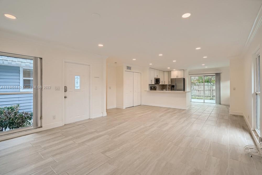 115 West Mango Road Lake Worth, FL 33467 - Photo 6 of 32 a view of an empty room and kitchen with furniture