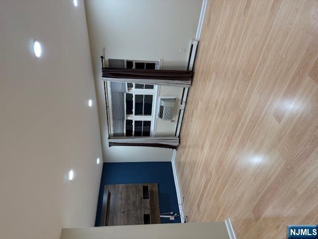 177 North Maple Avenue, Unit 177 Park Ridge, NJ 07656 - Photo 2 of 12 an empty room with wooden floor and window