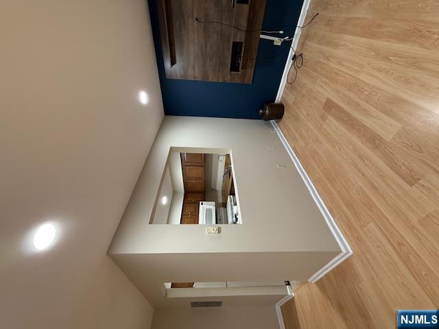 177 North Maple Avenue, Unit 177 Park Ridge, NJ 07656 - Photo 4 of 12 a view of an empty room with wooden floor and a kitchen