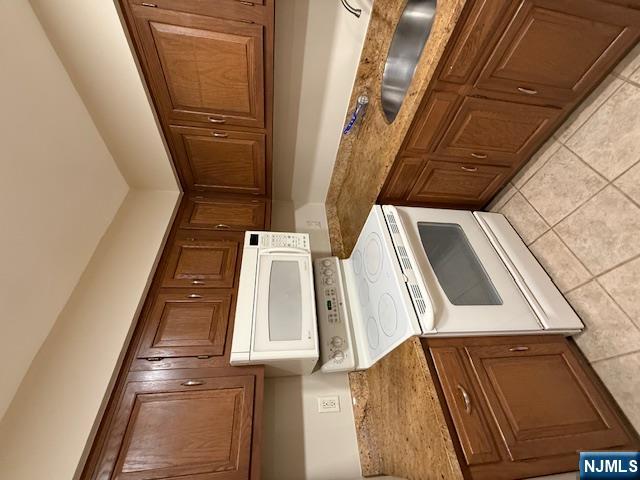 177 North Maple Avenue, Unit 177 Park Ridge, NJ 07656 - Photo 6 of 12 a kitchen with granite countertop cabinets and white stainless steel appliances