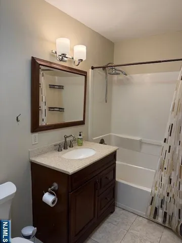 a bathroom with a sink vanity and a mirror