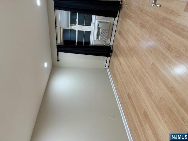 177 North Maple Avenue, Unit 177 Park Ridge, NJ 07656 - Photo 10 of 12 a view of empty room with wooden floor and stove