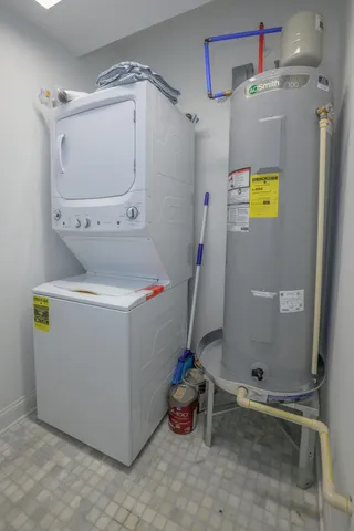 a utility room with a refrigerator and washer