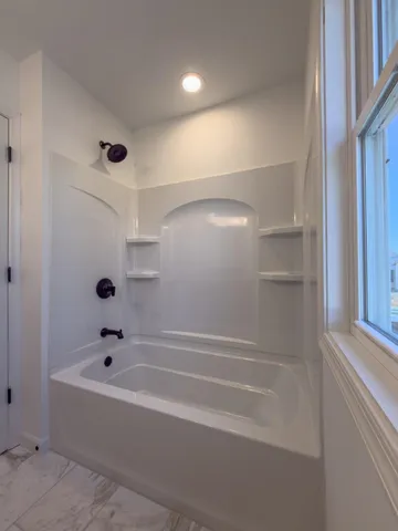 a bathroom with a bathtub and a shower