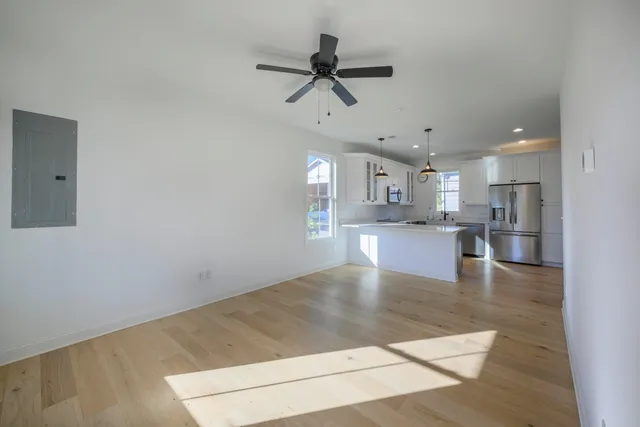 a view of kitchen with a refrigerator a microwave and a stove