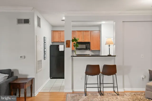 a kitchen with stainless steel appliances kitchen island granite countertop a refrigerator and a stove top oven