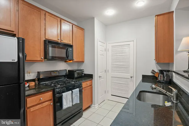 a kitchen with a sink stove and microwave
