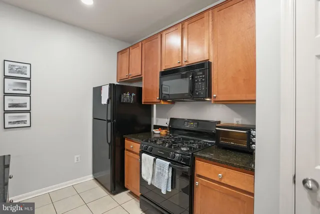 a kitchen with stainless steel appliances granite countertop a refrigerator stove and microwave