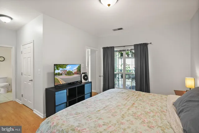 a bedroom with a bed and lamp