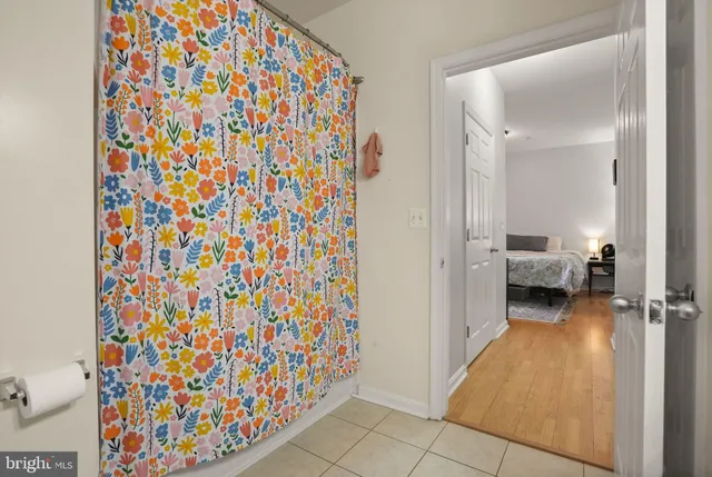 a bathroom with a granite countertop toilet sink and mirror