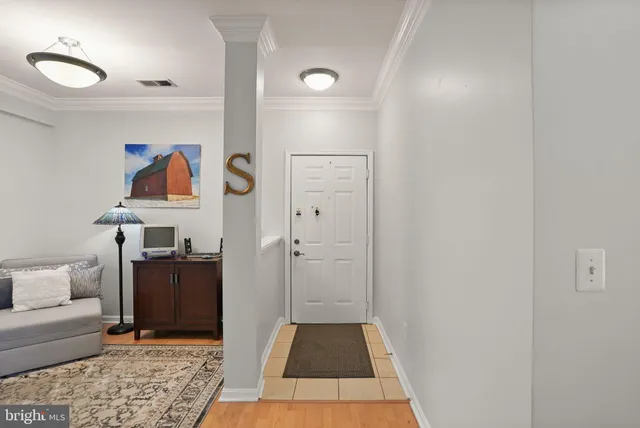 a living room with furniture and wall painting