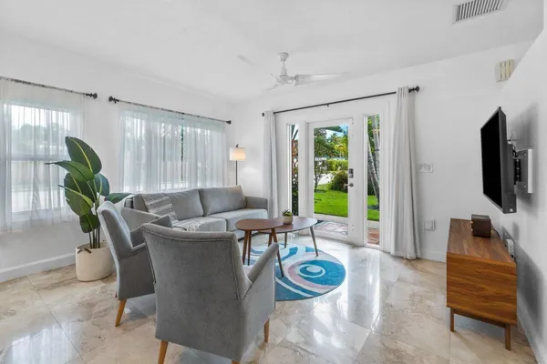 a living room with furniture and wooden floor