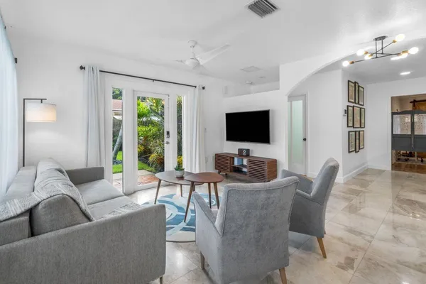 a living room with furniture and a potted plant